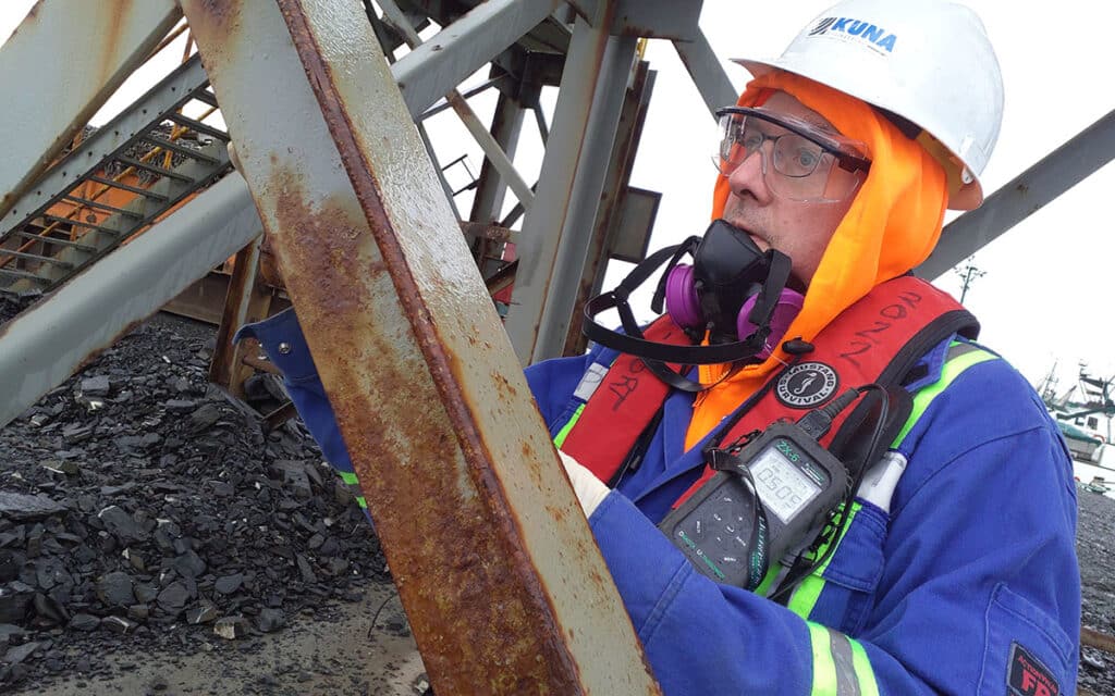 worker next to metal structure