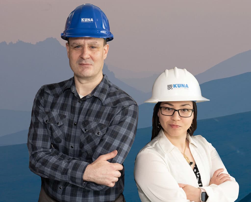 photo of two people in kuna hardhats