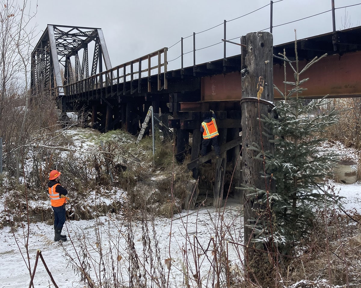 workers near train bridge