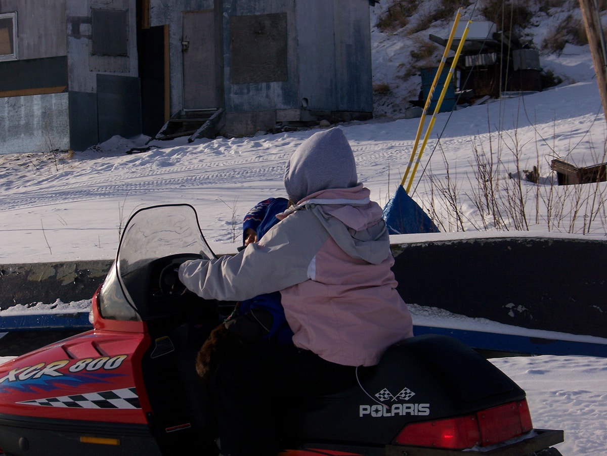 people on a snowmobile